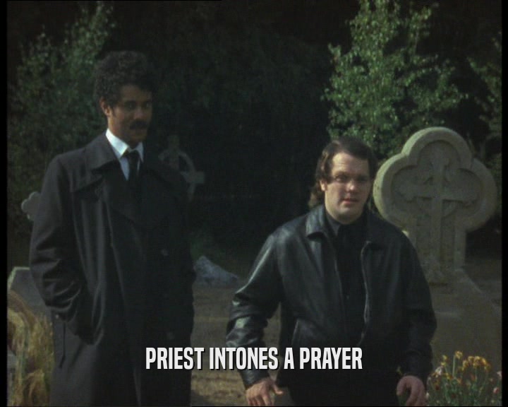PRIEST INTONES A PRAYER  