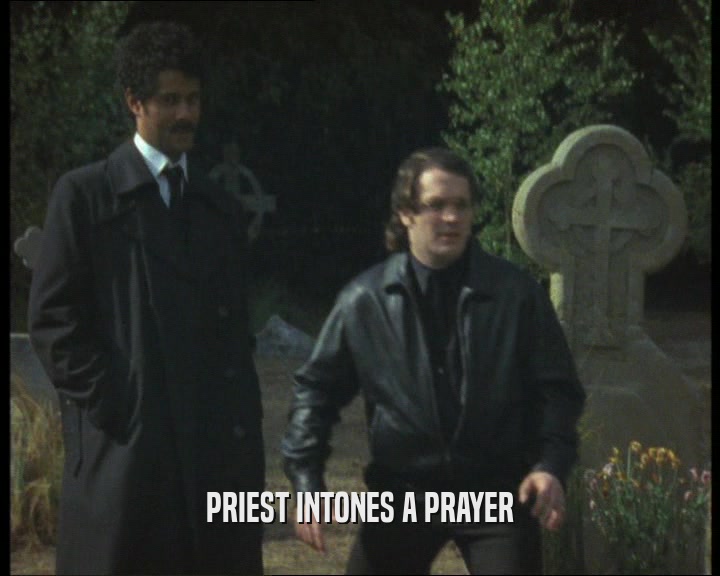 PRIEST INTONES A PRAYER  