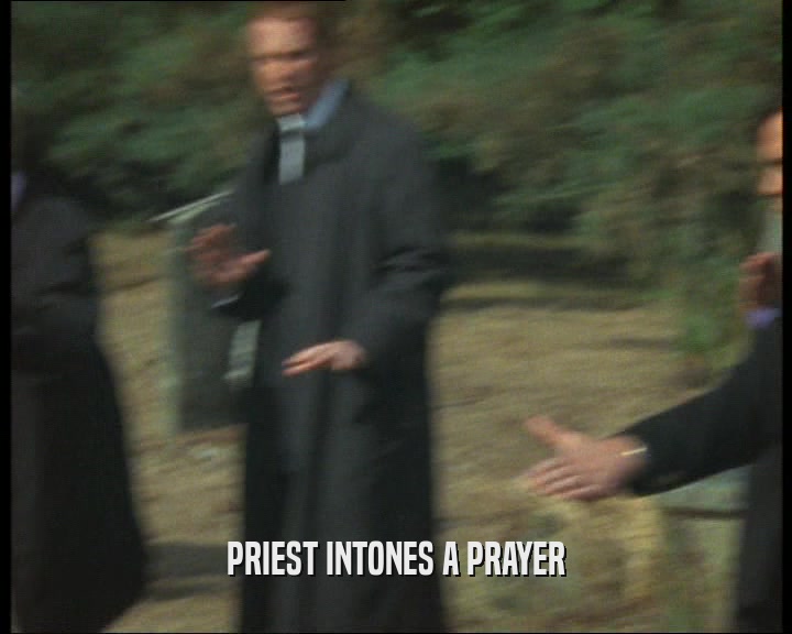 PRIEST INTONES A PRAYER  