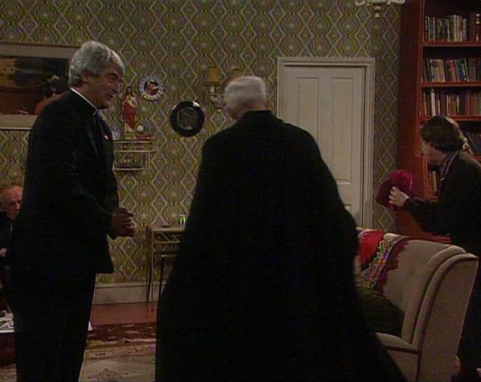 SIT DOWN THERE, YOUR GRACE, BESIDE FATHER DOUGAL. 