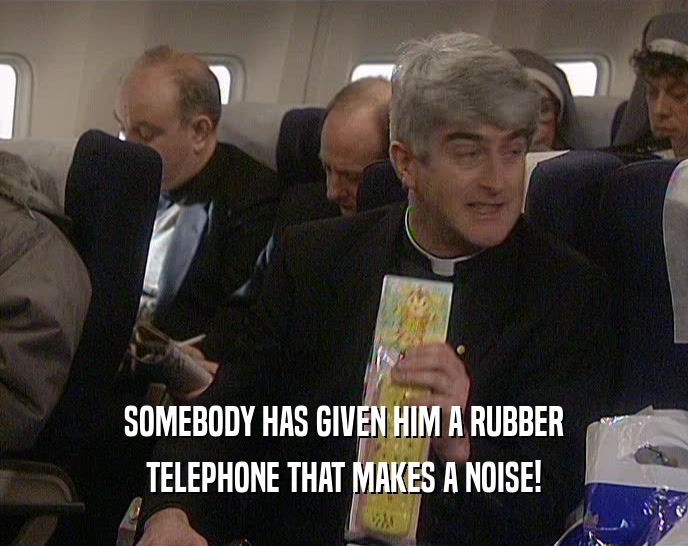 SOMEBODY HAS GIVEN HIM A RUBBER TELEPHONE THAT MAKES A NOISE! 