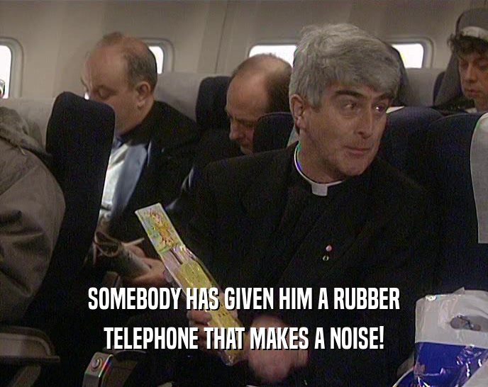 SOMEBODY HAS GIVEN HIM A RUBBER TELEPHONE THAT MAKES A NOISE! 