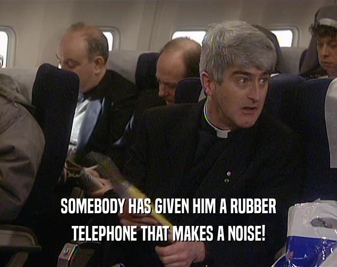 SOMEBODY HAS GIVEN HIM A RUBBER TELEPHONE THAT MAKES A NOISE! 