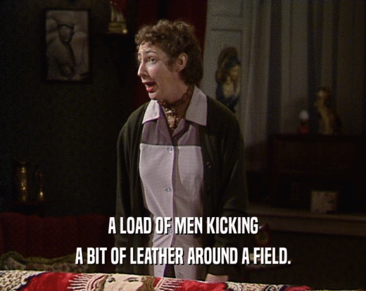 A LOAD OF MEN KICKING A BIT OF LEATHER AROUND A FIELD. 
