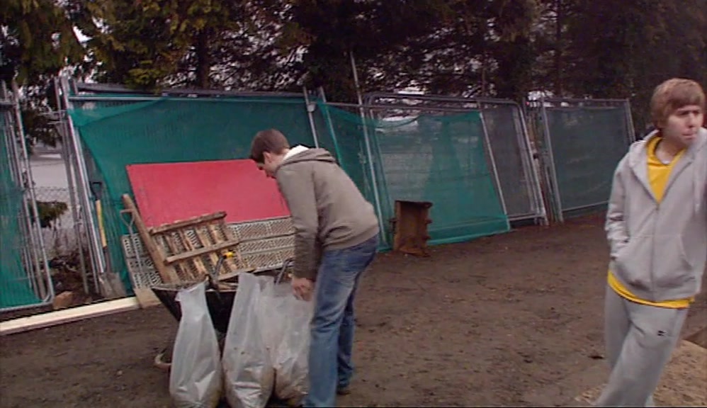FREEZING HIS ARSE OFF AT A DISGUSTING PLANT-HIRE YARD. 