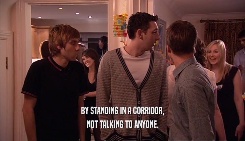 BY STANDING IN A CORRIDOR, NOT TALKING TO ANYONE. 