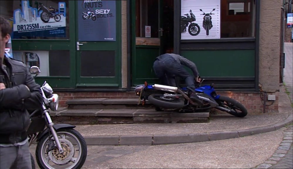 I THINK HE'S USED TO LEFT-HAND DRIVE. 