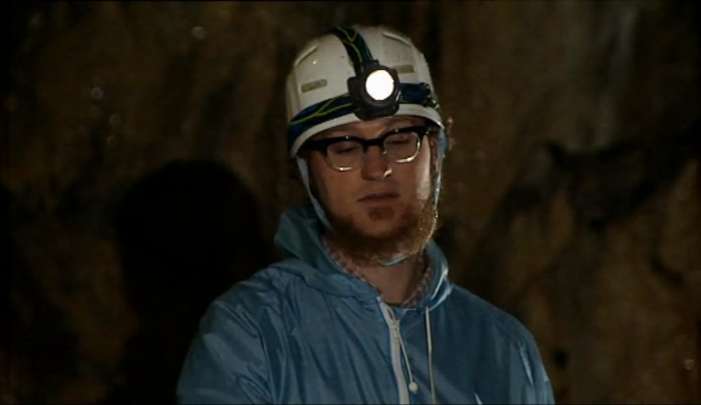 CLUTCHING AT A SLIPPERY, WET ROPE, SLIDING DOWN INTO THE DARK WATER. 