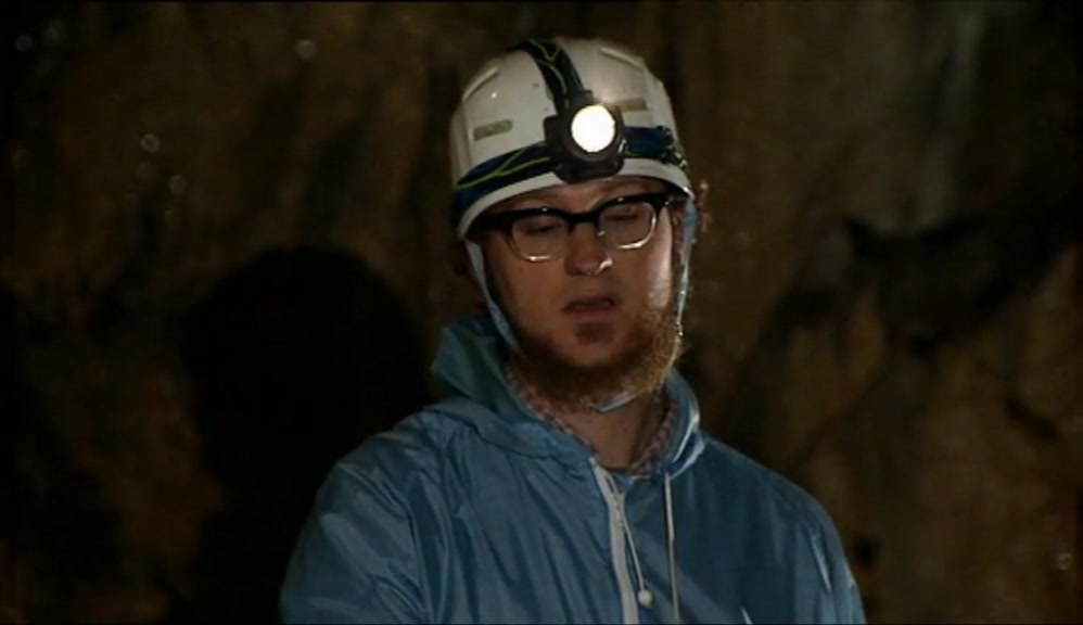 CLUTCHING AT A SLIPPERY, WET ROPE, SLIDING DOWN INTO THE DARK WATER. 