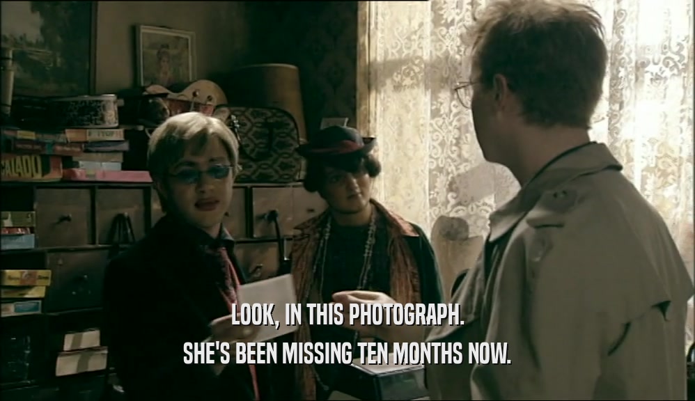 LOOK, IN THIS PHOTOGRAPH. SHE'S BEEN MISSING TEN MONTHS NOW. 