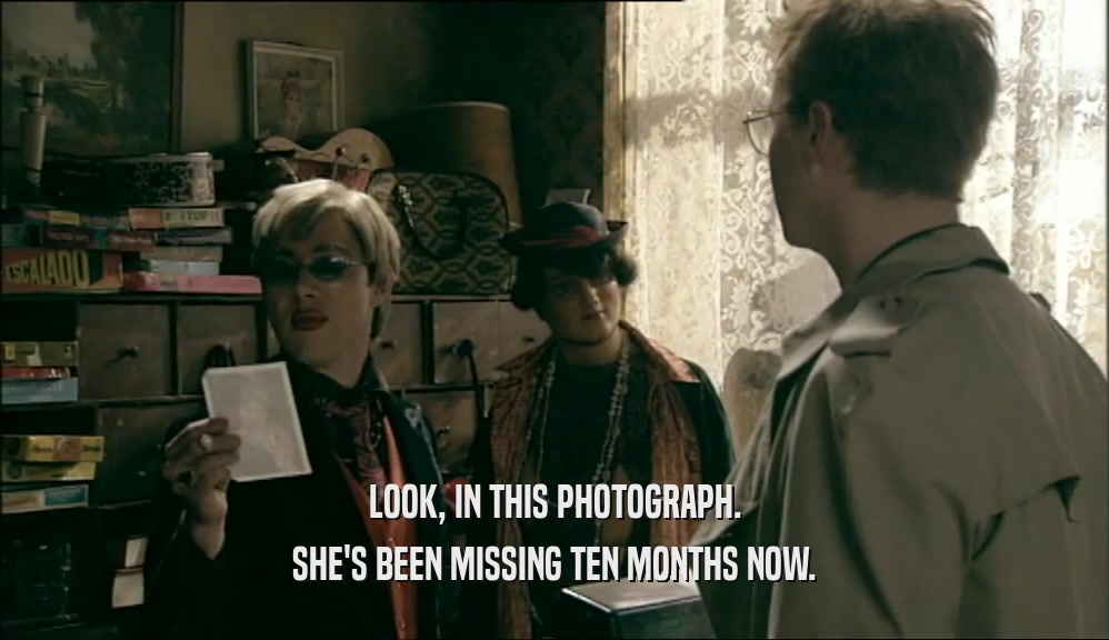 LOOK, IN THIS PHOTOGRAPH. SHE'S BEEN MISSING TEN MONTHS NOW. 
