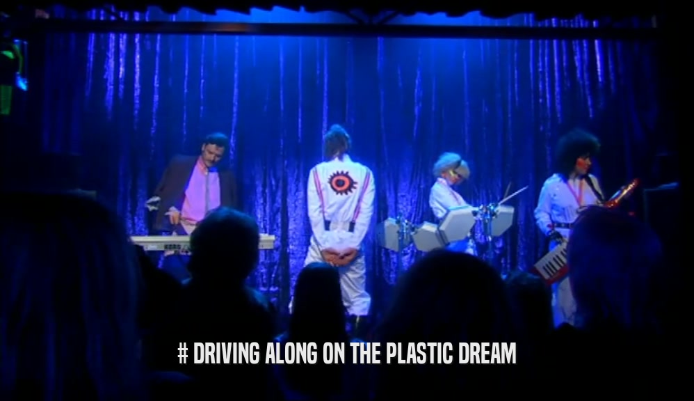 # DRIVING ALONG ON THE PLASTIC DREAM  