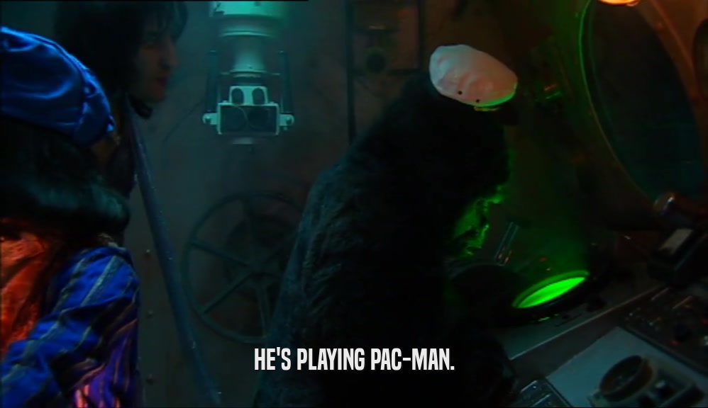 HE'S PLAYING PAC-MAN.  