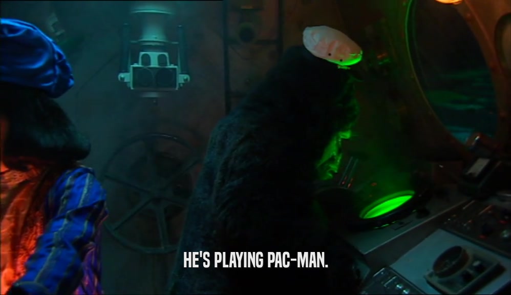 HE'S PLAYING PAC-MAN.  
