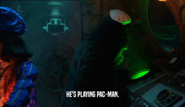 HE'S PLAYING PAC-MAN.  