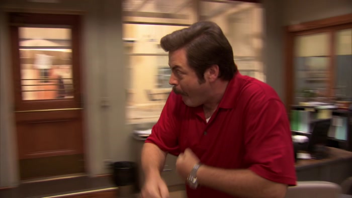 HE WEARS A RED SHIRT AND BLACK PANTS. 