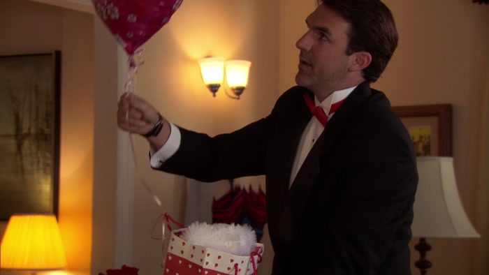 FIRST OFF, A BEAR IN A PAPER BAG AND A HEART-SHAPED BALLOON. 