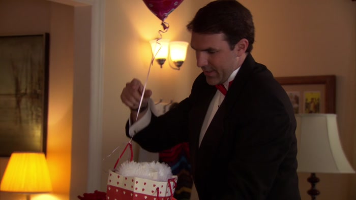 FIRST OFF, A BEAR IN A PAPER BAG AND A HEART-SHAPED BALLOON. 