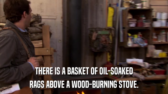 THERE IS A BASKET OF OIL-SOAKED RAGS ABOVE A WOOD-BURNING STOVE. 