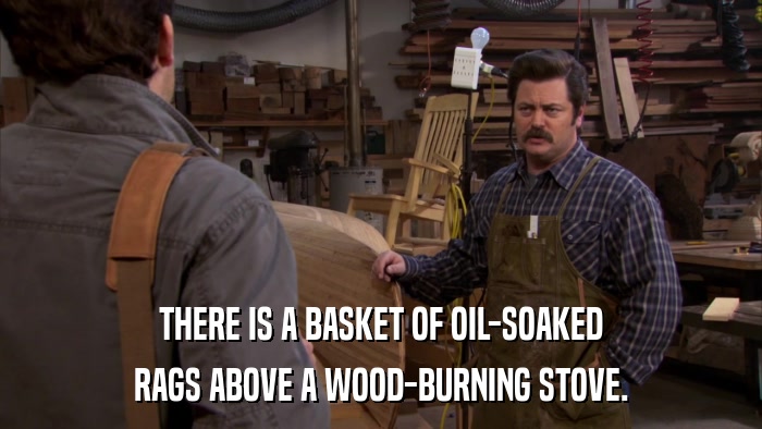THERE IS A BASKET OF OIL-SOAKED RAGS ABOVE A WOOD-BURNING STOVE. 