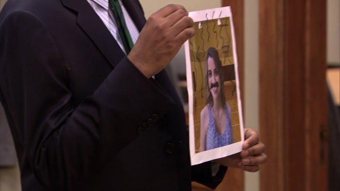 WITH A MUSTACHE DRAWN ON HER FACE 