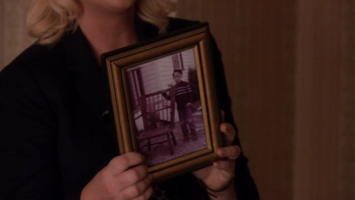 HE'S STANDING NEXT TO THE FIRST CHAIR 