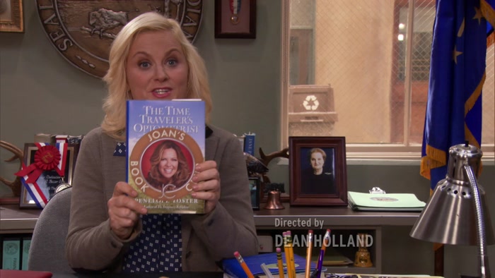 THEN JOAN SLAPS HER STICKER ON IT, 