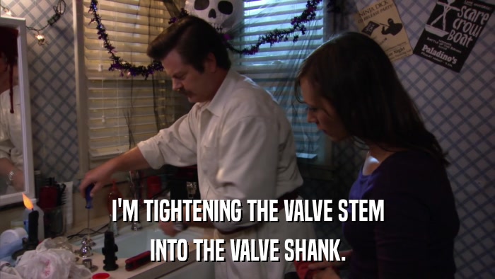 I'M TIGHTENING THE VALVE STEM INTO THE VALVE SHANK. 