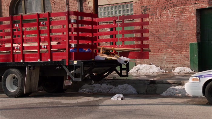 THE REAR OF THE VEHICLE'S OPEN, DEBRIS HAS BEEN FALLING OUT, 