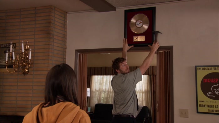 YEAH, HE WAS HANGING UP HIS GOLD RECORD. 