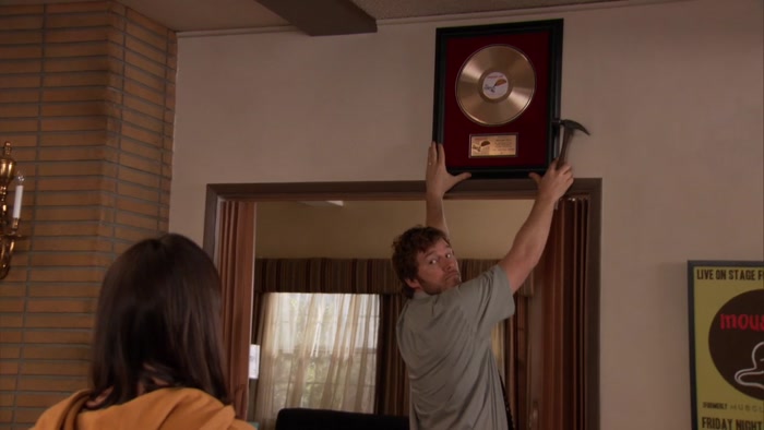 YEAH, HE WAS HANGING UP HIS GOLD RECORD. 