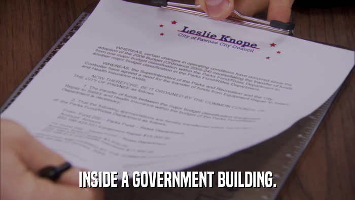 INSIDE A GOVERNMENT BUILDING.  