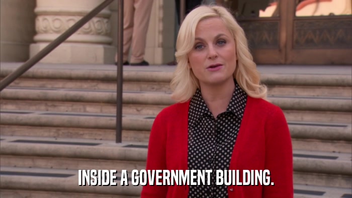 INSIDE A GOVERNMENT BUILDING.  
