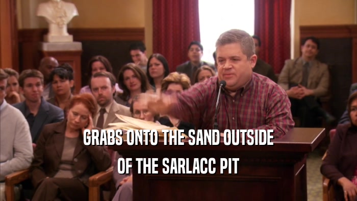 GRABS ONTO THE SAND OUTSIDE OF THE SARLACC PIT 