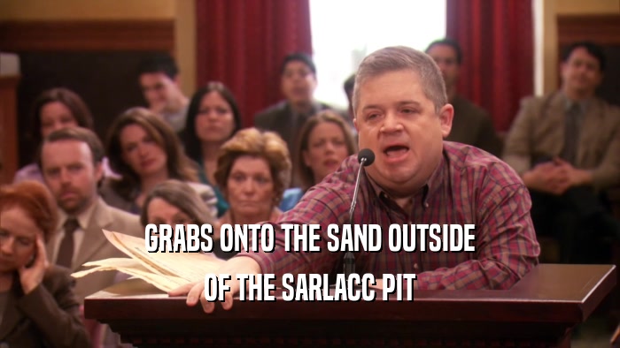 GRABS ONTO THE SAND OUTSIDE OF THE SARLACC PIT 
