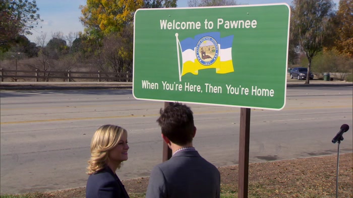 THE WRONG WAY AND IT'S WELCOMING YOU TO PAWNEE AS YOU'RE LEAVING. 