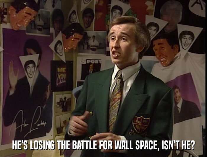 HE'S LOSING THE BATTLE FOR WALL SPACE, ISN'T HE?  