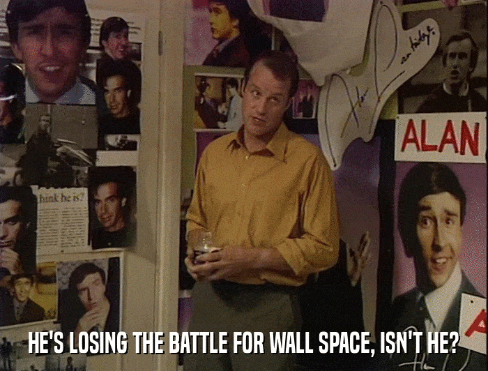 HE'S LOSING THE BATTLE FOR WALL SPACE, ISN'T HE?  