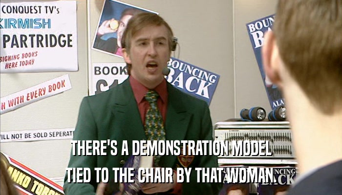 THERE'S A DEMONSTRATION MODEL TIED TO THE CHAIR BY THAT WOMAN. 