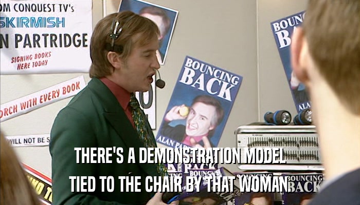 THERE'S A DEMONSTRATION MODEL TIED TO THE CHAIR BY THAT WOMAN. 