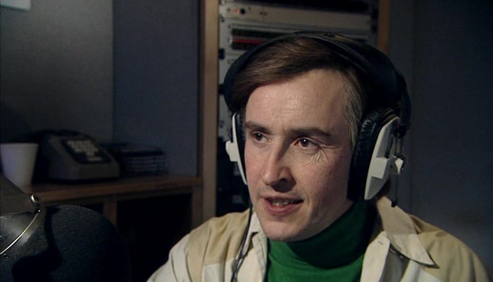 THERE GOES ALAN PARTRIDGE, LICENSED TO KILL...TIME BY WATCHING VIDEOS. 