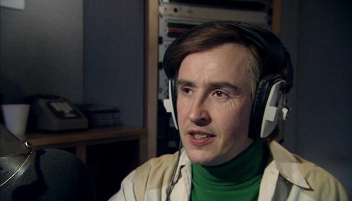 THERE GOES ALAN PARTRIDGE, LICENSED TO KILL...TIME BY WATCHING VIDEOS. 