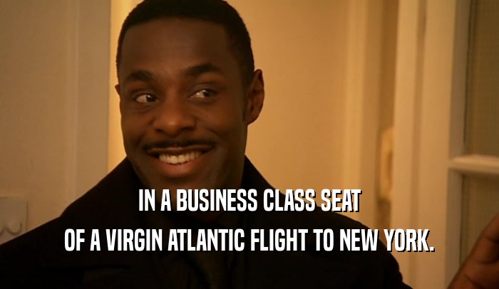 IN A BUSINESS CLASS SEAT OF A VIRGIN ATLANTIC FLIGHT TO NEW YORK. 