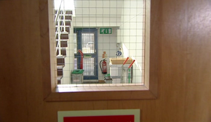 'FIRE EXIT. COULD BUST OUT HERE AND OUT INTO THE CAR PARK. 