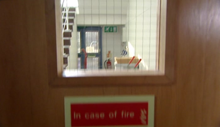 'FIRE EXIT. COULD BUST OUT HERE AND OUT INTO THE CAR PARK. 