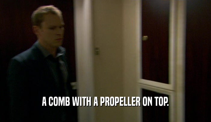 A COMB WITH A PROPELLER ON TOP.  