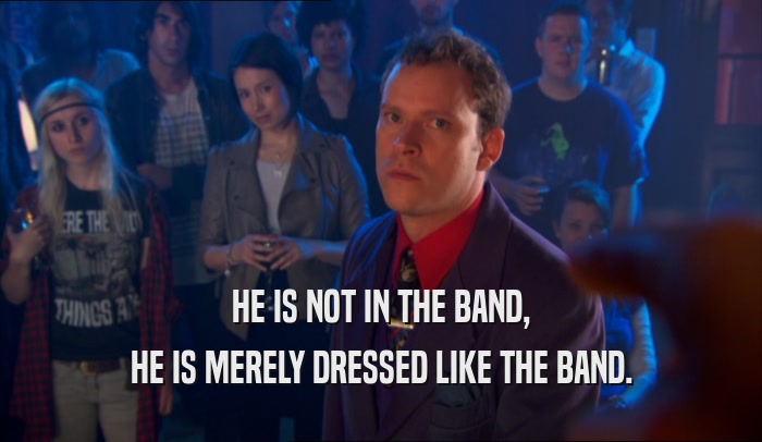 HE IS NOT IN THE BAND, HE IS MERELY DRESSED LIKE THE BAND. 