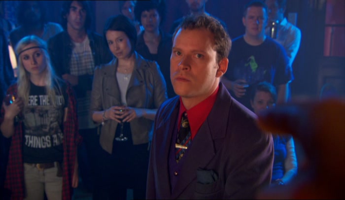 HE IS NOT IN THE BAND, HE IS MERELY DRESSED LIKE THE BAND. 