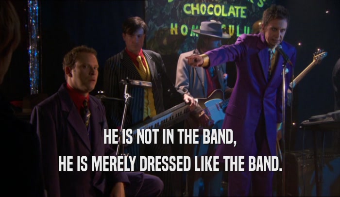 HE IS NOT IN THE BAND, HE IS MERELY DRESSED LIKE THE BAND. 