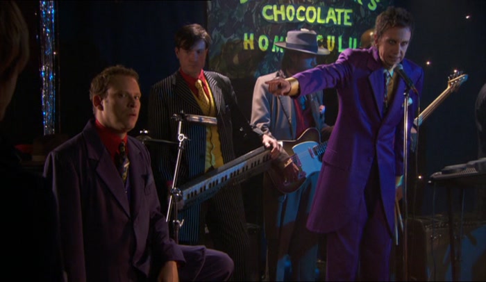 HE IS NOT IN THE BAND, HE IS MERELY DRESSED LIKE THE BAND. 